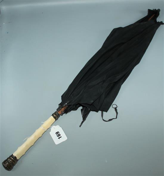 A silver and ivory umbrella and fans